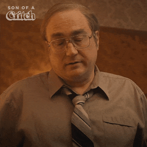 a man with glasses and a tie says " fine "