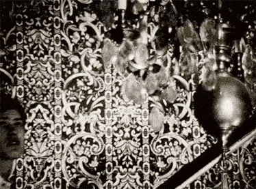 a black and white photo of a patterned wall