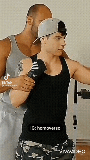a man and a boy are standing next to each other and the boy is wearing a hat