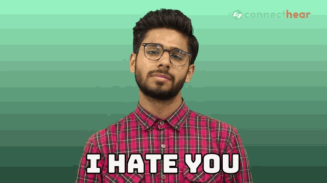 a man with glasses and a plaid shirt says " i hate you "