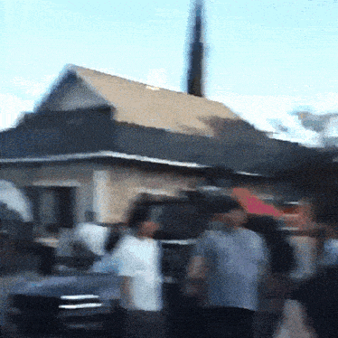 a blurry picture of people standing in front of a building