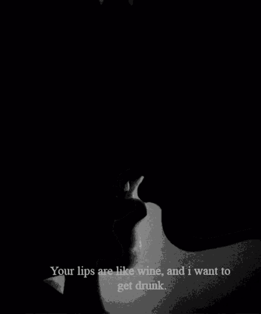 a black and white photo of a man and a woman kissing with the caption your lips are like wine and i want to get drunk