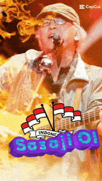 a man singing into a microphone next to a guitar