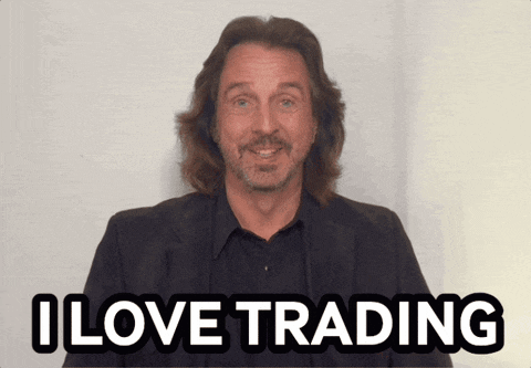 a man with long hair and a beard is smiling and says i love trading