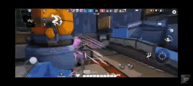 a video game is being played on a cell phone and a person is standing in the middle of a room .