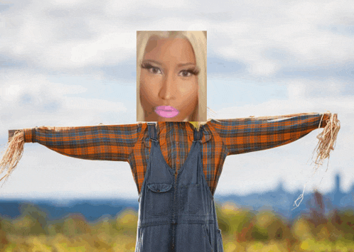 a scarecrow with a picture of nicki minaj on its face
