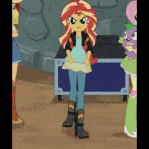 sunset shimmer from my little pony equestria girls is standing in front of a blue box with other girls .