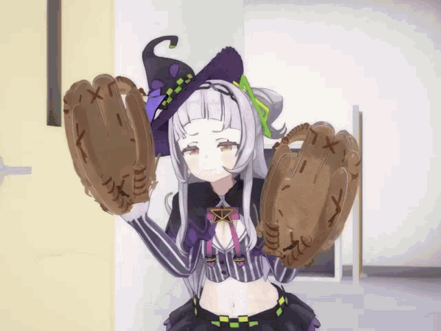 a girl in a witch costume is holding a pair of baseball gloves with the letters x on them