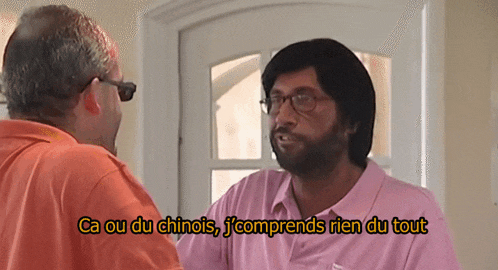 a man in a pink shirt is talking to another man