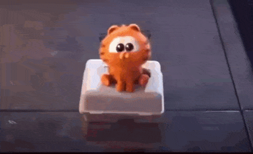 garfield is pointing at a boy in a cartoon while talking to him .