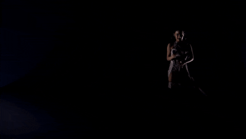 a woman in a white dress and over the knee boots is kneeling down on a white floor .