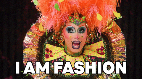 a drag queen says i am fashion in front of a colorful costume