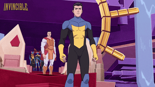 a man in a superhero costume is standing in front of a sign that says invincible