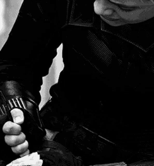 a black and white photo of a person in a black leather jacket