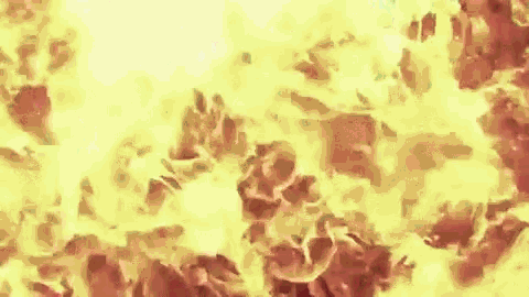 a close up of a fire with a lot of flames and smoke