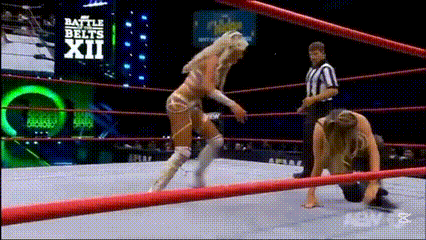 a woman in a wrestling ring with the words battle belts xii