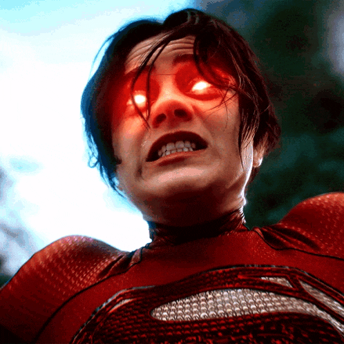 a close up of a person 's face with bright red eyes
