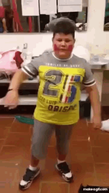 a boy wearing a yellow shirt that says brisa is dancing
