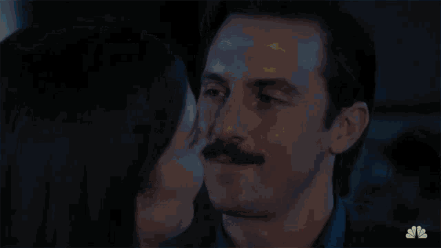 a man with a mustache is kissing a woman with the words happily ever after behind them