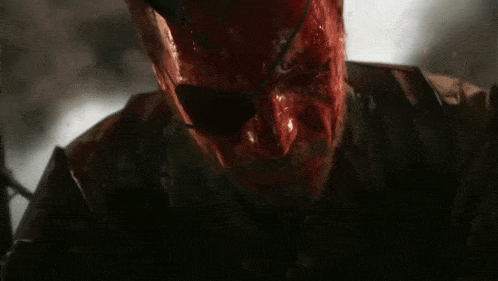 a close up of a man with blood on his face and the words `` it 's peak '' below him .