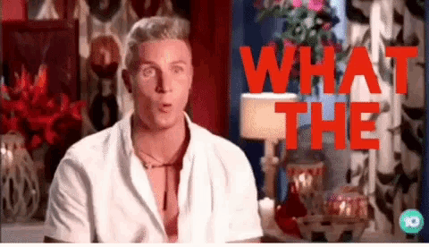 a man in a white shirt is standing in front of a sign that says " what the "
