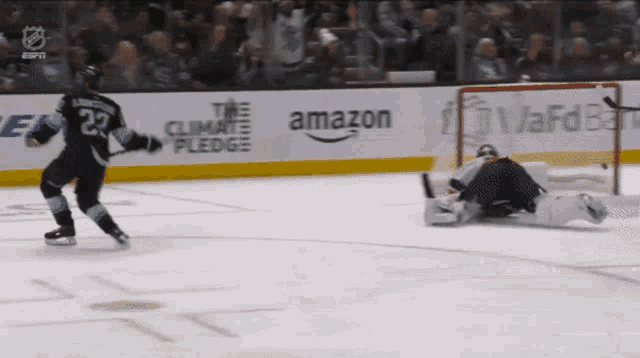a hockey player with the number 23 on his jersey is skating on the ice