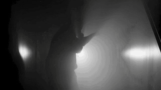 a silhouette of a person in a dark room