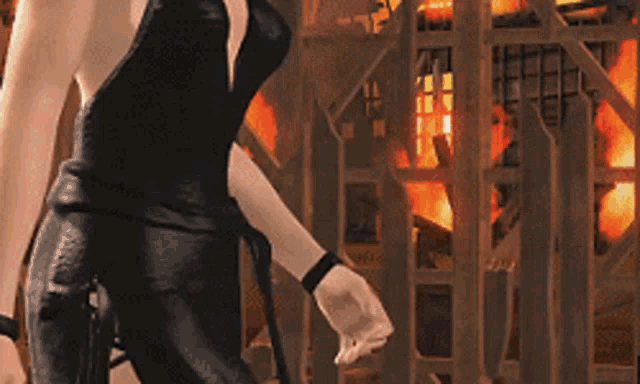 a woman in a black dress stands in front of a fire
