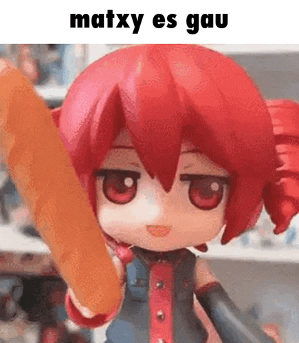 a doll with red hair is holding a stick in her hand and says matxy es gau .