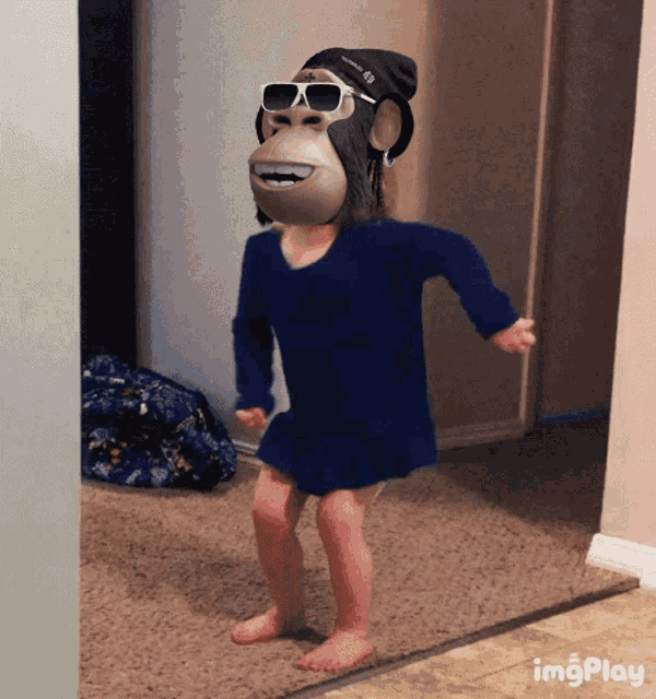 a little girl wearing a gorilla mask and sunglasses is dancing in a hallway