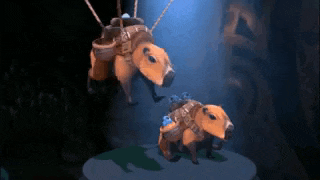a couple of stuffed animals hanging from ropes in a dark room .