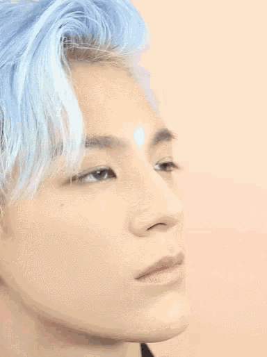 a close up of a man with blue hair
