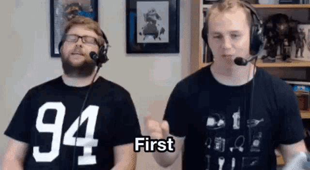 two men wearing headphones and t-shirts with 94 and first on them