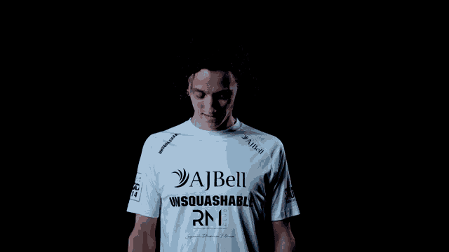 a man wearing a white shirt that says ajbell