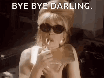 a woman in sunglasses is smoking a cigarette and saying `` bye bye darling . ''