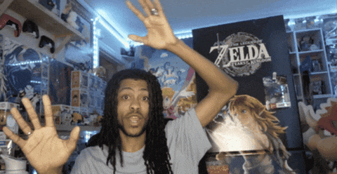a man standing in front of a zelda poster