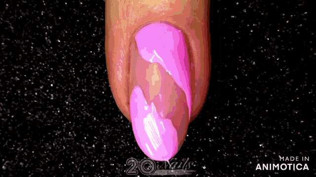 a close up of a person 's nails with pink nail polish