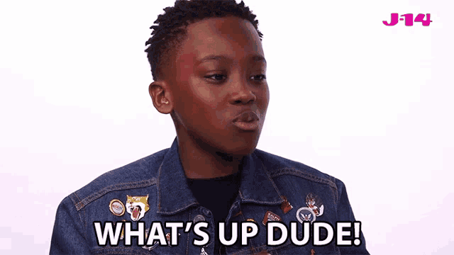 a young boy wearing a denim jacket says " what 's up dude "