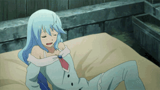 a girl with blue hair laying on a bed with her eyes closed