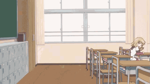 a girl sitting at a desk in a classroom
