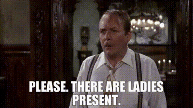 a man in a white shirt and tie is standing in front of a mirror and says `` please , there are ladies present . ''