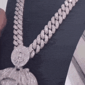 a close up of a diamond necklace with a lion pendant