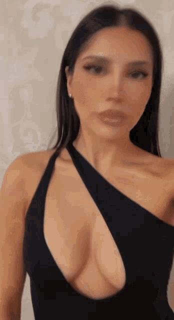 a woman in a black dress with a very plunging neckline