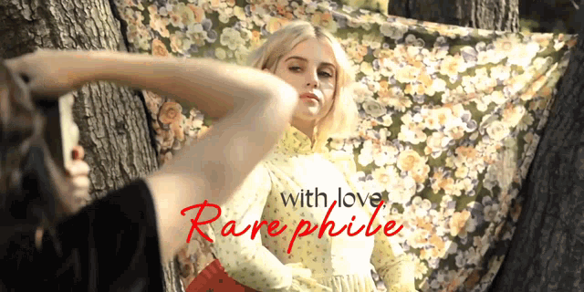 a woman in a floral dress is being photographed with the words " with love rarephile " in red