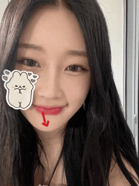 a girl with a sticker on her face has a red arrow pointing up