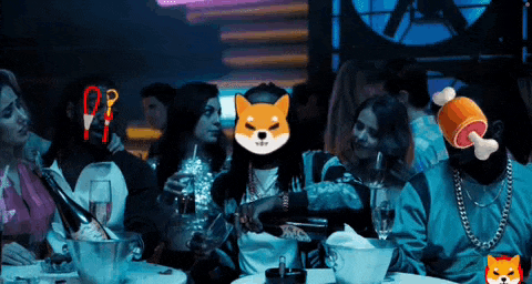 a group of people are sitting at a table in a club with a dog on their head .