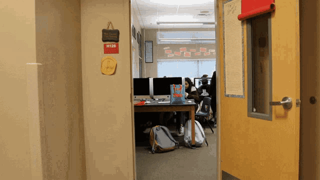 a classroom with a sign that says w128