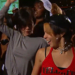 a woman in a red tank top with the word vibe on it is dancing