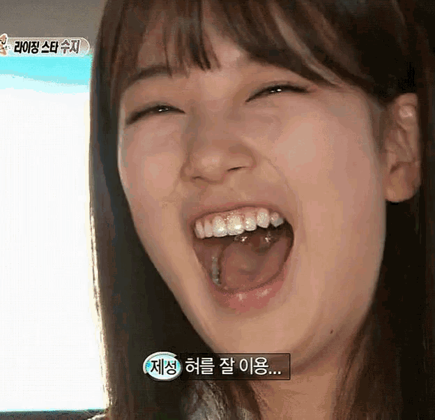 a close up of a woman 's face with her mouth open and a sign that says ' a ' on it