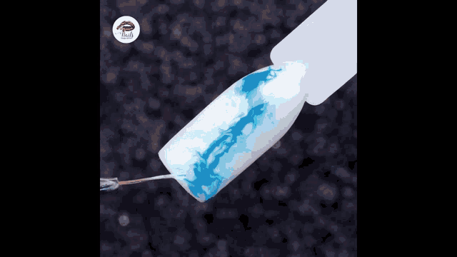 a person is holding a jar of blue and white glitter